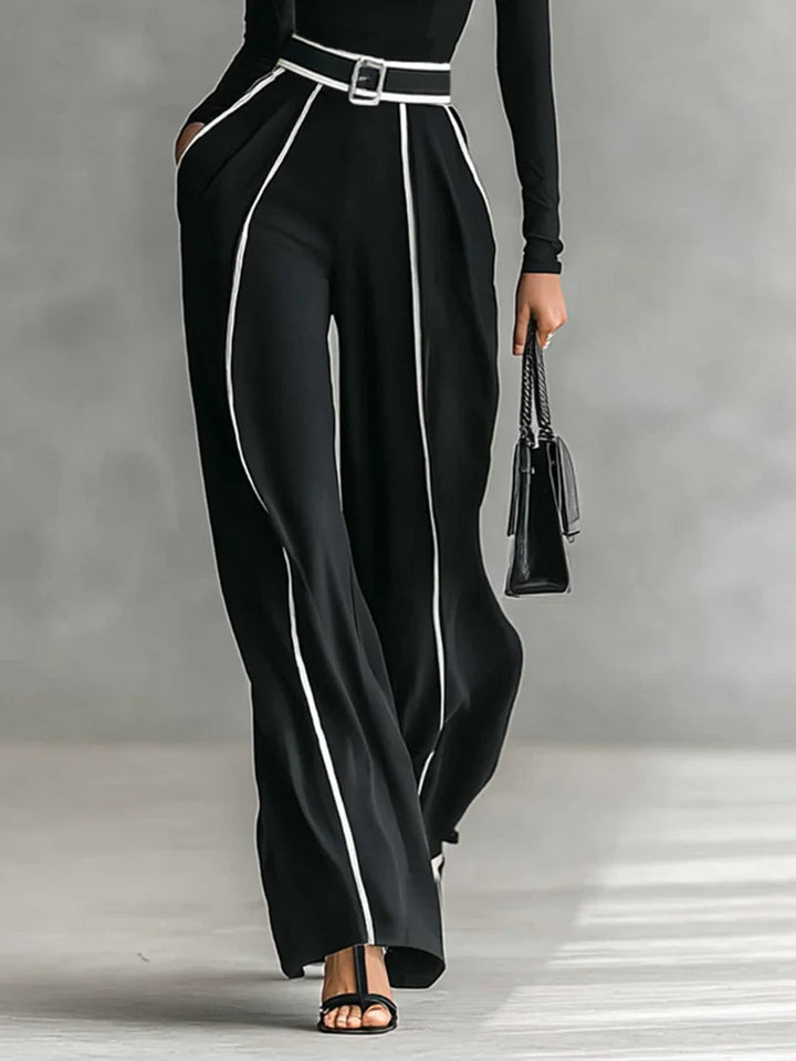 Set with finished top featuring a high neck and long sleeves, wide pants, and belt